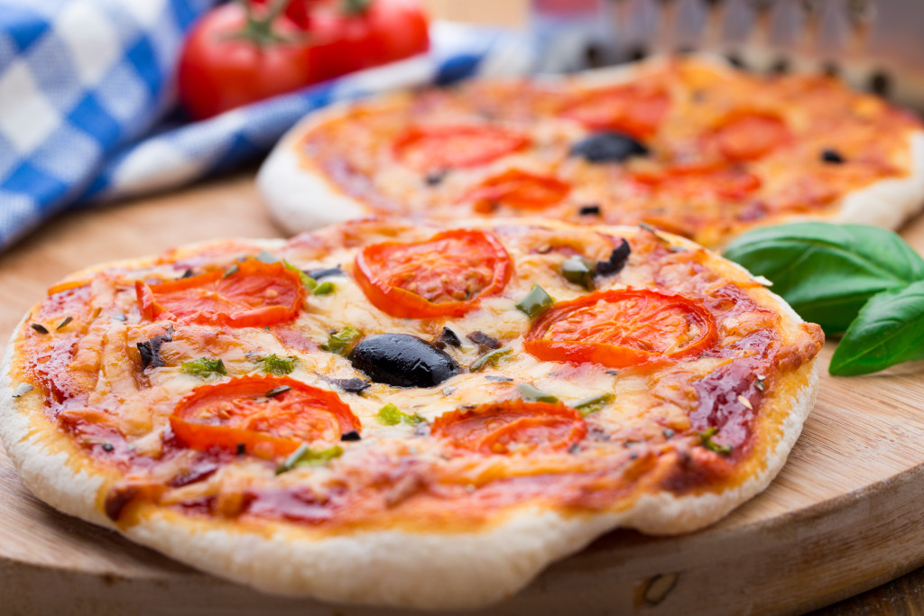 Vegetarian mini pizza with cherry tomatoes, paprika and olives