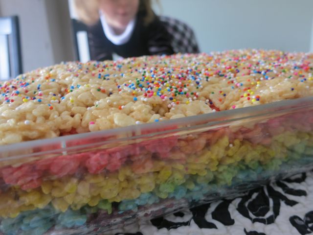 These Rainbow Rice Krispie treats are perfect for St Patrick's Day, bake sales, birthday parties, or just an everyday fun treat for kids! #womenlivingwell #desserts #ricekrispietreats #easyrecipes