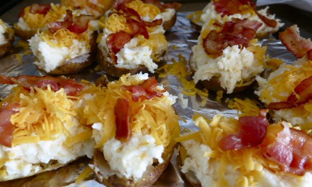 These twice baked potatoes are easy to make and the most delicious ones you'll try. Cheese, sour cream, bacon and a secret ingredient for the ultimate yum! #easyrecipe #potato #sidedish