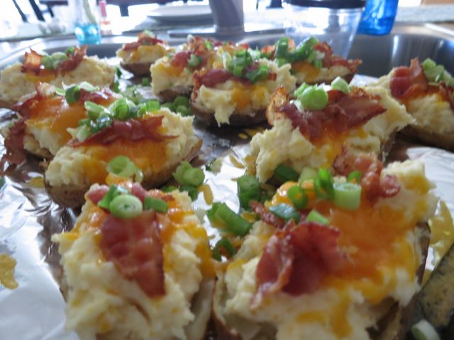 These twice baked potatoes are easy to make and the most delicious ones you'll try. Cheese, sour cream, bacon and a secret ingredient for the ultimate yum! #easyrecipe #potato #sidedish